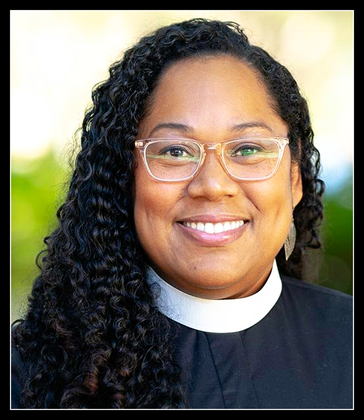 A picture of Pastor Antoinette smiling for the camera. She appears to be outside.