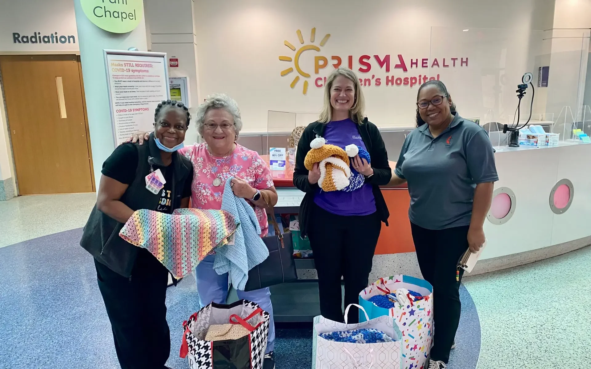 A group of volunteers pose for a photo at Prisma Health after donating prayer shawls.